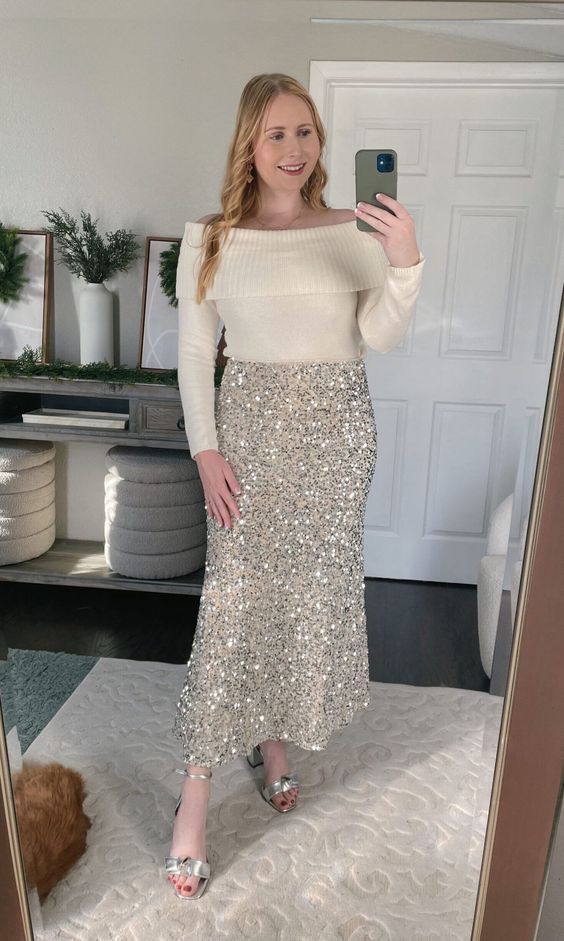 a glam party look with a white off the shoulder jumper, a gold sequin midi, silver heels is amazing