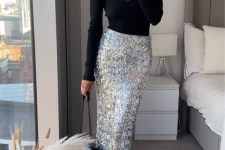 a glam party outfit with a black long sleeve top with a deep neckline, a silver sequin midi, black embellished shoes and a bag