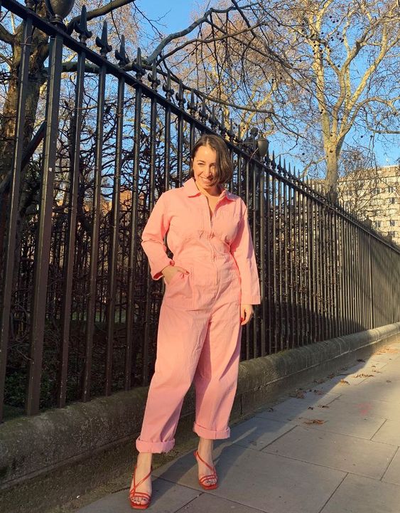 a gorgeous peachy pink denim jumpsuit with long sleeves, red strappy shoes for a lovely spring look