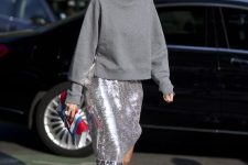a grey sweatshirt, a silver sequin midi skirt and silver lacing up shoes is a stylish and refined outfit