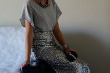 a grey tee, a silver maxi skirt, a statement necklace and a velvet clutch for a simple festive outfit