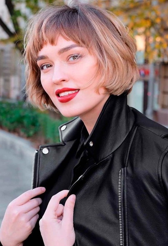 a jaw-length brunette bob with blonde balayage and waves plus bangs is a catchy idea, which looks effortless