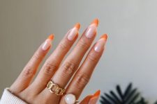 a lovely and trendy manicure, a creative take on French nails, with blush, creamy and orange to pull off that Peach Fuzz tone