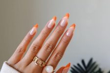 a lovely and trendy manicure, a creative take on French nails, with blush, creamy and orange to pull off that Peach Fuzz tone