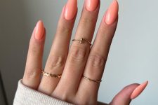 a lovely bright peachy manicure of a pointed lamond shape is a super cool and catchy idea