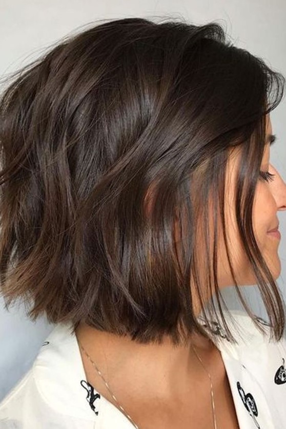 a lovely chocolate brown mid bob with a lot of volume and some wavy texture is a cool idea for anyone