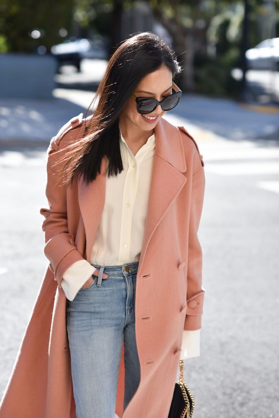 a lovely spring look with a neutral button down, blue jeans, a Peach Fuzz coat and a black bag with gold chain