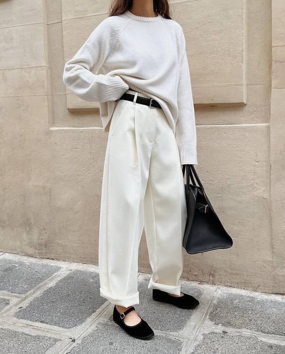 a minimalist outfit with a white jumper and trosuers, black Mary Jane shoes, a belt and a tote is cool