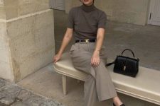 a minimalist work outfit with a taupe top, grey trousers, black Mary Jane shoes and a black belt and bag