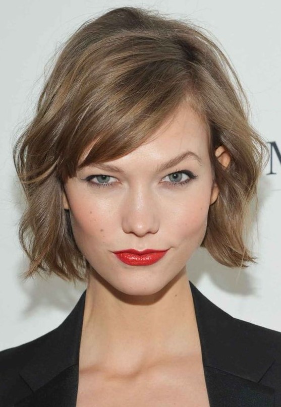 A mousy brown jaw length bob with side bangs and messy waves is a lovely solution with effortless chic