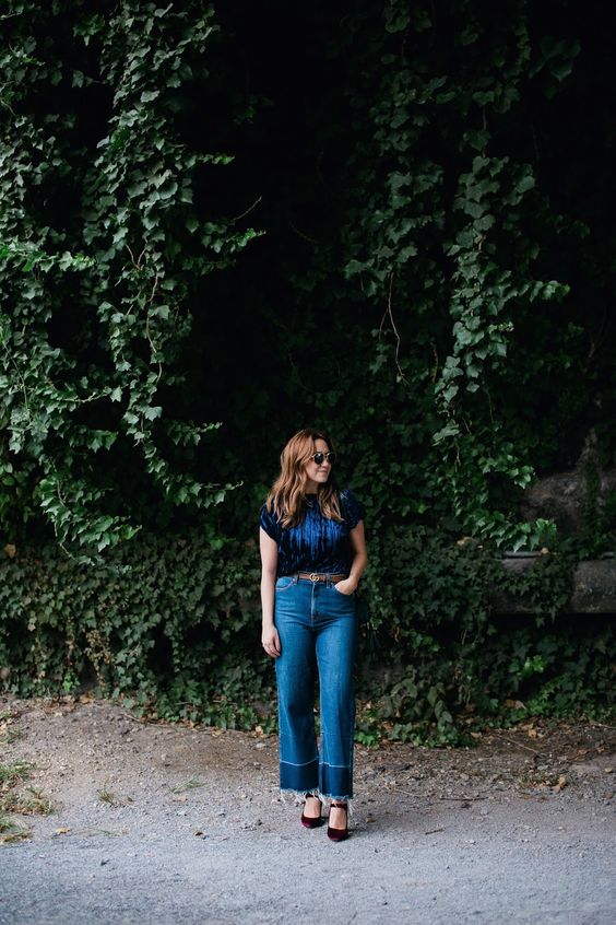 a navy velvet top, blue jeans, a brown belt and burgundy velvet Mary Jane shoes are a lovely fall look