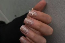 a nude manicure with colorful sparkles is a lovely idea for NYE and will look fine after that, too