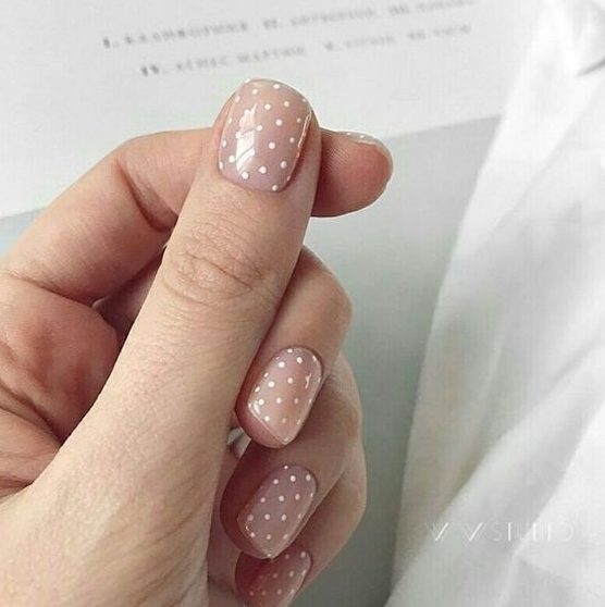 a nude manicure with white polka dots is a timeless and girlish idea to try, this is a cute touch to your look