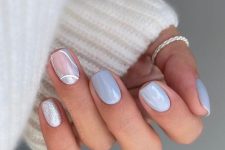 a pastel blue manicure with a swirl accent nail and a silver glitter one is a cool idea for spring