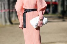 a pink to Peach Fuzz textural midi dress with accented shoulders, black slingbacks, a black belt and a white bag