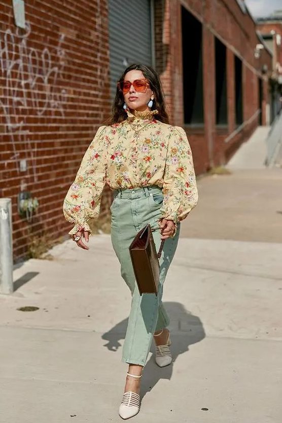 a pretty and elegant vintage-inspired wedding guest look with a tan floral blouse with puff sleeves, mint-colored pants, white shoes and a brown bag