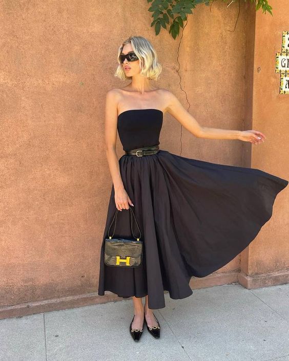 a refined special occasion look with a strapless top, a full skirt with a belt, black embellished and a small bag