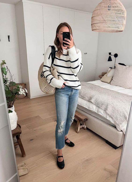 a relaxed spring look with a striped jumper, blue jeans, black Mary Jane shoes and a woven tote