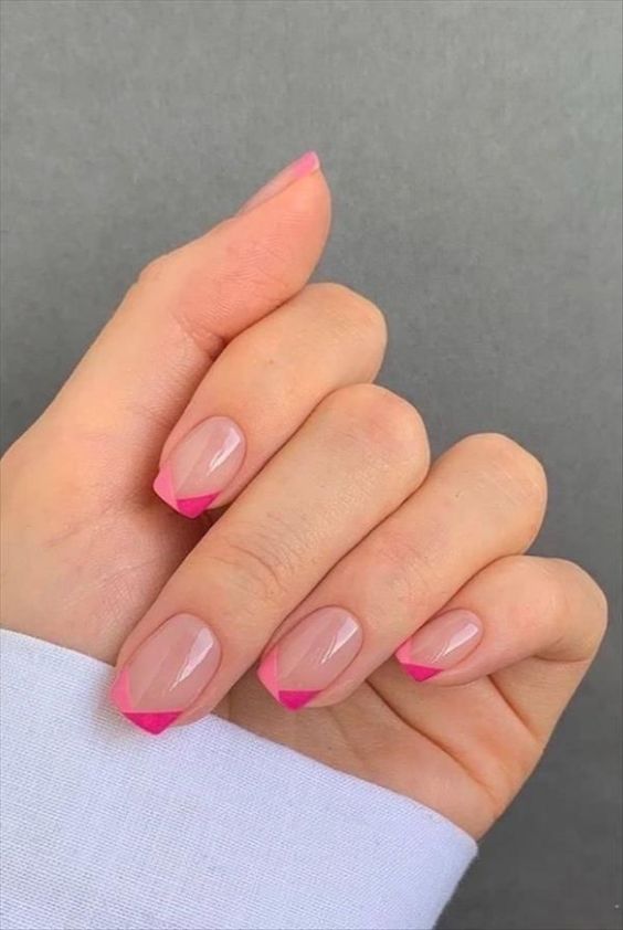 a short square manicure with a bright modern version of French nails, with hot pink and light pink geometric tips