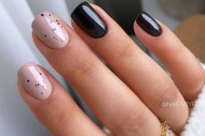 a short square manicure with black and blush speckled nails are a cool and catchy solution