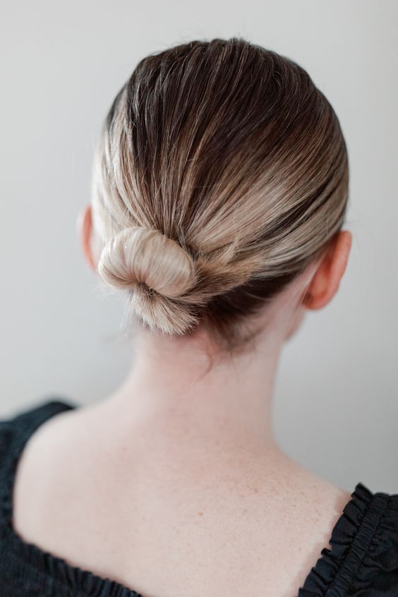 a sleek low wrapped bun with a sleek top is a cool and super elegant idea for a special occasion