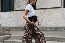 a statement yet causal summerlook with a white tee, dark floral culottes, gold shoes and statement earrings