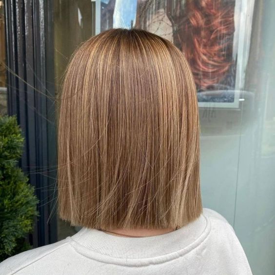 a straight light brown blunt bob with a bit of blonde highlights plus volume is a cool and catchy idea