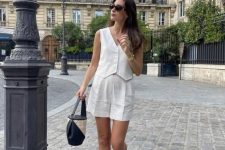 a summer old money look with a waistcoat, cropped shorts, two-tone shoes and a two-tone bag is cool and easy to recreate