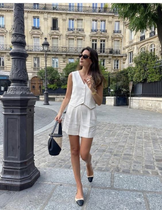 A summer old money look with a waistcoat, cropped shorts, two tone shoes and a two tone bag is cool and easy to recreate