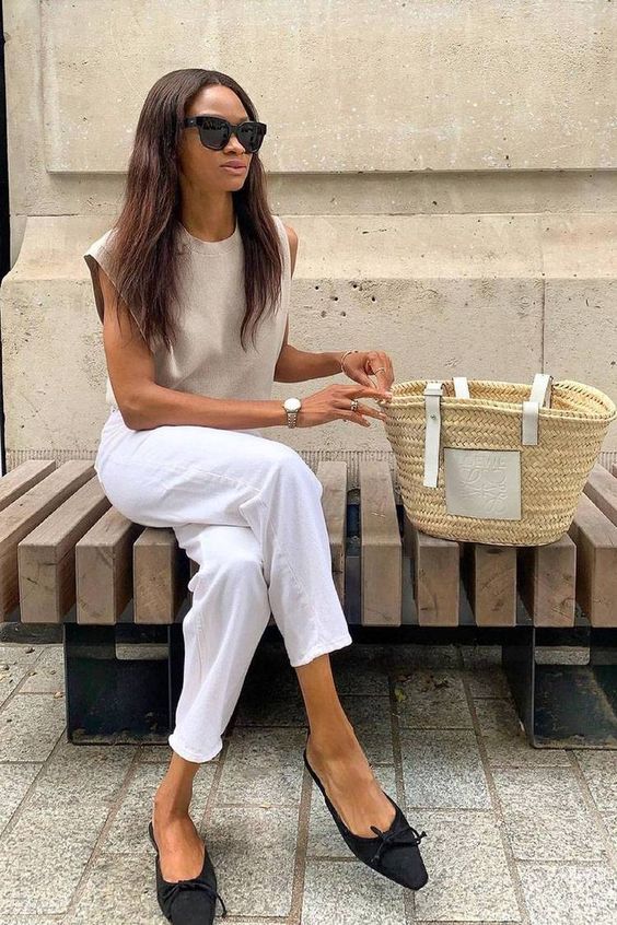 a summer outfit with a sleeveless top, white jeans, black flats with bows and a basket bag is amazing