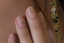 a super glam wedding manicure in blush, with large gold rhinestones is amazing for a glam look at a NYE party