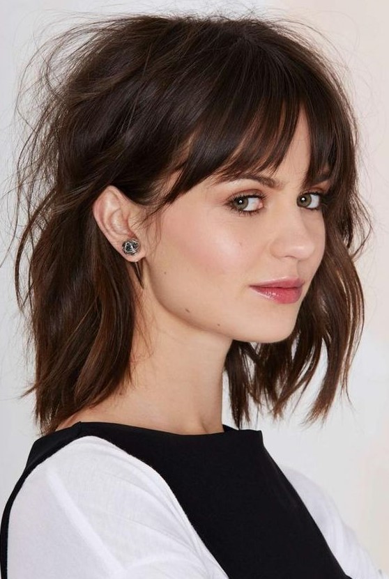 A textural and messy long bob with bangs and done in cold brew tones is a very chic and very French like hairstyle