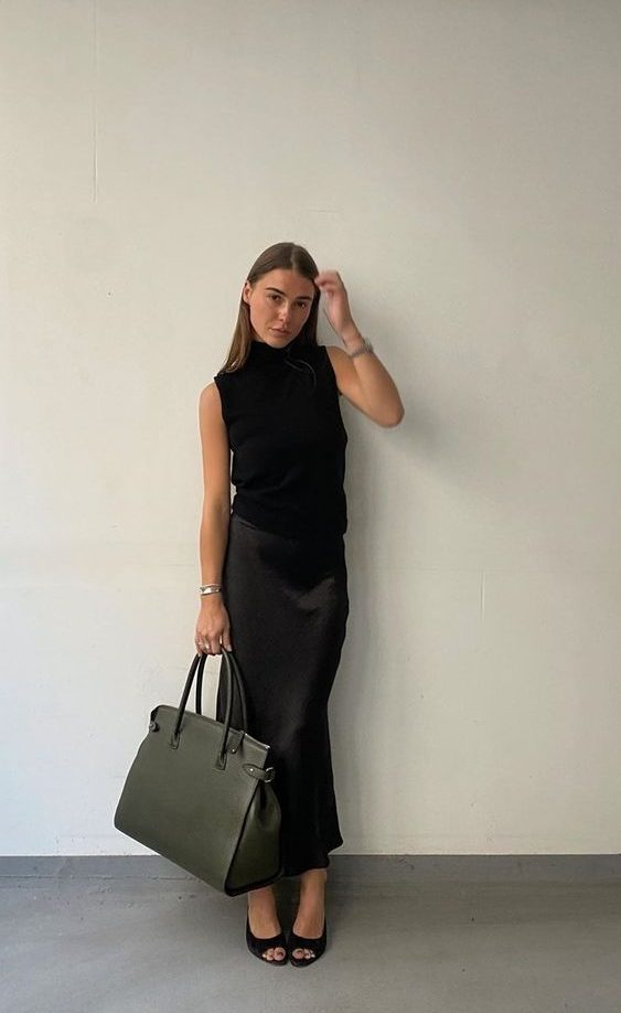 a total black look with a sleeveless top, a maxi skirt, peep toe shoes and a large tote for work