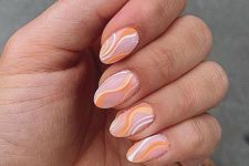 a trendy almond-shaped manicure with an abstract pattern, with white and Peach Fuzz touches