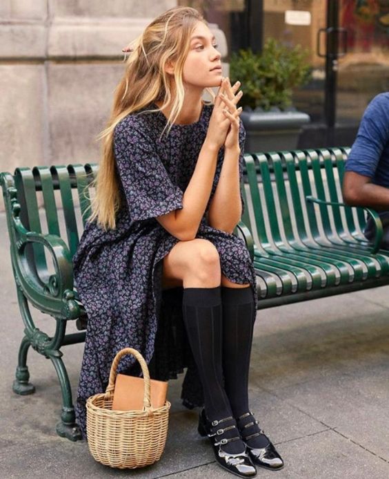 a vintage-inspired outfit with a navy floral midi dress, black Mary Jane shoes and socks plus a basket