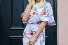 a white floral print over the knee dress with ruffled sleeves and a high neckline, a box bag and sunglasses
