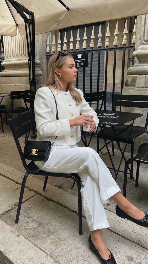 a white old money look with a cropped blazer, trousers, black flats and a black bag with gold details