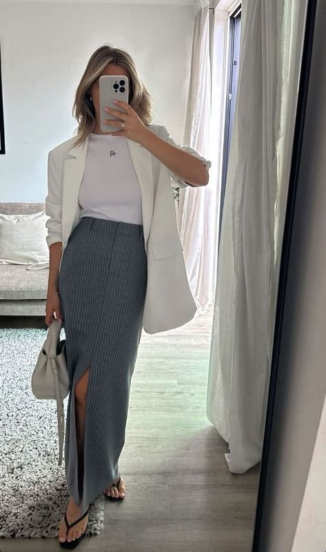 a white t-shirt, a grey thin stripe maxi with a front slit, a long white blazer and flipflops plus a small bag