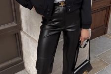 a white t-shirt, black leather trousers, a black cropped blazer, black slingbacks and a small black bag with gold details