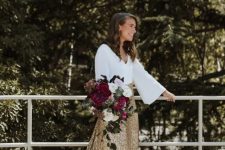 a white top with bell sleeves and a gold glitter skirt with a train can be rocked a s asecond wedding ensemble or for a bridal shower