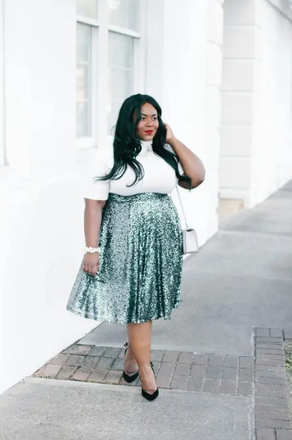 a white turleneck with short sleeves, a green high waist sequin midi, black shoes and an off-white bag