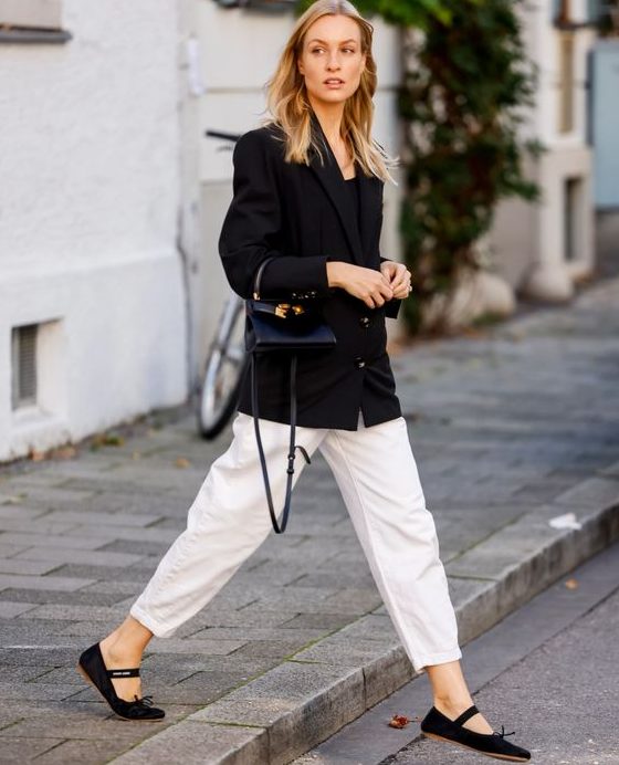 a work look with an oversized black blazer, white jeans, black Mary Jane shoes and a small black bag