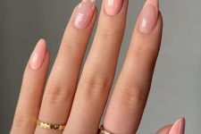 almond-shaped Peach Fuzz nails with an accent floral and French finger are a cool and delicate idea