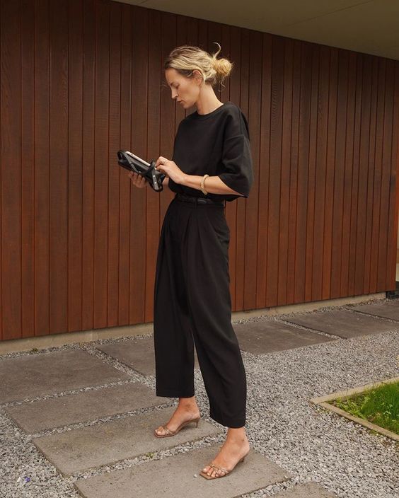 An every day quiet luxury look with a black t shirt, high waisted pants, minimal nude kitten heels and a small bag