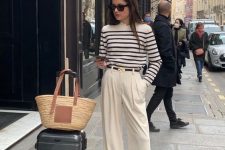 an old money outfit with a striped top, creamy trousers, black shoes, a black belt and a woven bag is a cool idea
