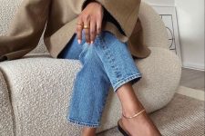 an oversized beige blazer, blue jeans, black flats, a gold naklet and gold rings for a glam look
