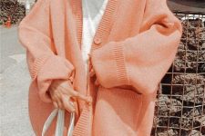 an oversized peachy pink cardigan with pockets and buttons will be a nice cover up for winter, spring or fall