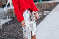 an oversized red chunky sweater, a silver sequin midi skirt with a slit, a grey bag and nude heels plus statement earrings