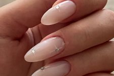 beautiful long almond-shaped nude nails with rhinestones are adorable for any glam-loving bride