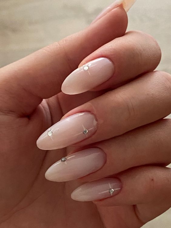 beautiful long almond-shaped nude nails with rhinestones are adorable for any glam-loving bride